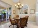 Charming dining area with a round table and four chairs near the kitchen at 824 Blue Crane Dr, Venice, FL 34285