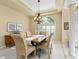 Well-lit dining room featuring a wooden table and six chairs at 824 Blue Crane Dr, Venice, FL 34285