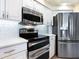 Stainless steel appliances and white cabinetry in this well-equipped kitchen at 824 Blue Crane Dr, Venice, FL 34285