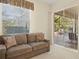 Living room with sliding doors opening to a view of the pool at 824 Blue Crane Dr, Venice, FL 34285