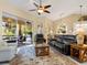 Spacious living room with leather furniture and access to the lanai at 824 Blue Crane Dr, Venice, FL 34285