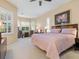 Bright main bedroom with a king-size bed and plantation shutters at 824 Blue Crane Dr, Venice, FL 34285