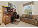 Home office with a large desk, comfortable couch, and built-in shelving at 824 Blue Crane Dr, Venice, FL 34285