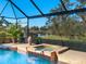 Relaxing pool and spa with a view of a lake at 824 Blue Crane Dr, Venice, FL 34285