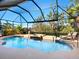 Inviting swimming pool and spa with screened enclosure at 824 Blue Crane Dr, Venice, FL 34285