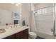 Clean bathroom with tub shower, vanity, and toilet at 10788 Trophy Dr, Englewood, FL 34223