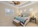 Bright bedroom with large windows, plush carpet, and ceiling fan at 10788 Trophy Dr, Englewood, FL 34223