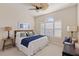 Guest bedroom with window shutters, ceiling fan, and comfortable bedding at 10788 Trophy Dr, Englewood, FL 34223