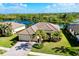 Single-Gathering home with tile roof, driveway, and landscaping at 20314 Passagio Dr, Venice, FL 34293