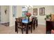 Bright dining room with a dark wood table and six chairs at 20314 Passagio Dr, Venice, FL 34293