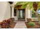 Elegant entryway with glass front door and brick walkway at 20314 Passagio Dr, Venice, FL 34293