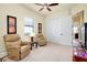 Bright home office with two recliners, a media console and built-in closet at 20314 Passagio Dr, Venice, FL 34293