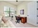 Bright home office features built-in desk, comfortable seating, and large window at 20314 Passagio Dr, Venice, FL 34293