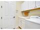 Laundry room with washer, dryer, cabinets at 20314 Passagio Dr, Venice, FL 34293