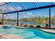 Enjoy this refreshing pool and spa with a screened enclosure and lake view at 20314 Passagio Dr, Venice, FL 34293