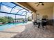 Outdoor patio with pool, table, and grill at 20314 Passagio Dr, Venice, FL 34293