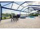 Covered patio with seating area adjacent to a refreshing pool and spa at 20314 Passagio Dr, Venice, FL 34293