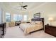 Primary bedroom with king-size bed and sitting area at 20314 Passagio Dr, Venice, FL 34293