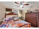 Charming bedroom with a wooden bed frame, unique bedding, and a dresser at 2191 Park Rd, Venice, FL 34293