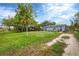 Front yard view of a light gray house with landscaping at 2191 Park Rd, Venice, FL 34293