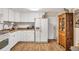 White kitchen features wood floors and an antique cabinet at 2191 Park Rd, Venice, FL 34293