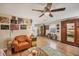 Living room with a comfy chair, unique decor, and hardwood floors at 2191 Park Rd, Venice, FL 34293