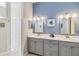 Double vanity bathroom with modern fixtures and gray cabinets at 2232 Lynx Run, North Port, FL 34286