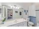 Bathroom with updated vanity, mirror, and shower/tub at 2232 Lynx Run, North Port, FL 34286