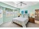 Main bedroom with a king-size bed and soft green walls at 2232 Lynx Run, North Port, FL 34286