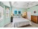 Main bedroom with king-size bed, ceiling fan and ensuite bathroom at 2232 Lynx Run, North Port, FL 34286