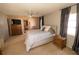 Main bedroom with plush carpeting, large bed, and wood nightstand at 338 Woodvale Dr, Venice, FL 34293