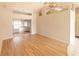 Living room with sliding doors to the backyard and wood-look flooring at 338 Woodvale Dr, Venice, FL 34293