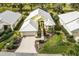 Aerial view of a yellow house with white roof, landscaping, and driveway at 340 Bermuda Ct # 5, Venice, FL 34293