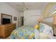 Guest bedroom with dresser, double closet and tropical bedding at 340 Bermuda Ct # 5, Venice, FL 34293