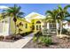 Beautiful yellow house with lush tropical landscaping and a welcoming entrance at 340 Bermuda Ct # 5, Venice, FL 34293