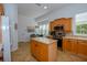 Bright kitchen with island, stainless steel appliances, and light wood cabinets at 340 Bermuda Ct # 5, Venice, FL 34293