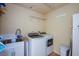 Bright laundry room with washer, dryer, and utility sink at 340 Bermuda Ct # 5, Venice, FL 34293