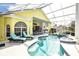 Resort-style pool and spa with lounge chairs and outdoor kitchen at 340 Bermuda Ct # 5, Venice, FL 34293