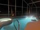 Inviting pool and spa at night with underwater lighting at 340 Bermuda Ct # 5, Venice, FL 34293