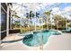 Relaxing pool and spa with tiled accents and screened enclosure at 340 Bermuda Ct # 5, Venice, FL 34293