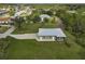 Aerial view of single-story house with gray siding, large yard, and screened patio at 4130 Rock Creek Dr, Port Charlotte, FL 33948