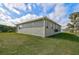 Single story house with gray siding, landscaped yard, and screened patio at 4130 Rock Creek Dr, Port Charlotte, FL 33948