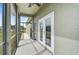 Spacious screened porch with french doors leading to the backyard at 4130 Rock Creek Dr, Port Charlotte, FL 33948