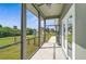 Relaxing screened porch overlooking backyard with lush greenery at 4130 Rock Creek Dr, Port Charlotte, FL 33948