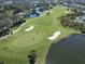 Aerial view of golfers on a lush green at 444 Pinewood Lake Dr, Venice, FL 34285