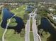 Aerial view of community, highlighting roads and waterways at 444 Pinewood Lake Dr, Venice, FL 34285