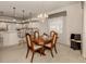 Dining area with kitchen view, breakfast bar and chandelier at 444 Pinewood Lake Dr, Venice, FL 34285