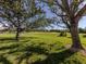 Serene view of a golf course from under large trees at 444 Pinewood Lake Dr, Venice, FL 34285