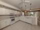 Spacious kitchen with white cabinets and tile floors at 444 Pinewood Lake Dr, Venice, FL 34285