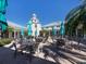 Relaxing clubhouse patio with tables and umbrellas at 444 Pinewood Lake Dr, Venice, FL 34285